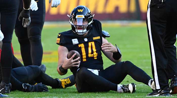 Commanders QB Sam Howell sits on the ground after being sacked